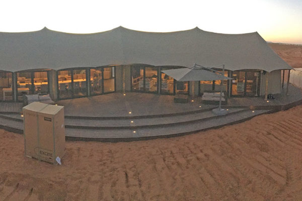 Exterior of tent with a wooden deck in the desert