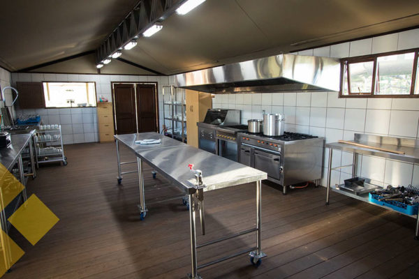 Commercial kitchen with gas stove, prep area and grill