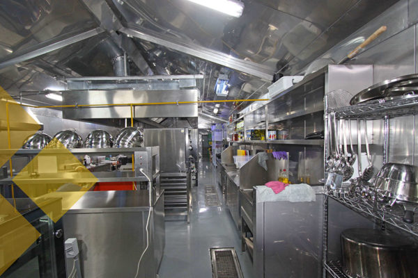 Interior of commercial kitchen with pots and pans and utensils
